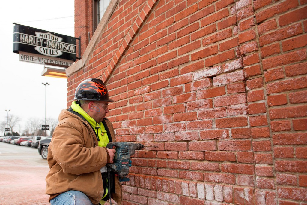     Mason Kenneth Glyzewski removes bricks from the Harley-Davidson facility, which will be placed at a Harley-Davidson plaza in Sturgis, South Dakota. Photo: CNW Group/Deeley Harley-Davidson Canada.